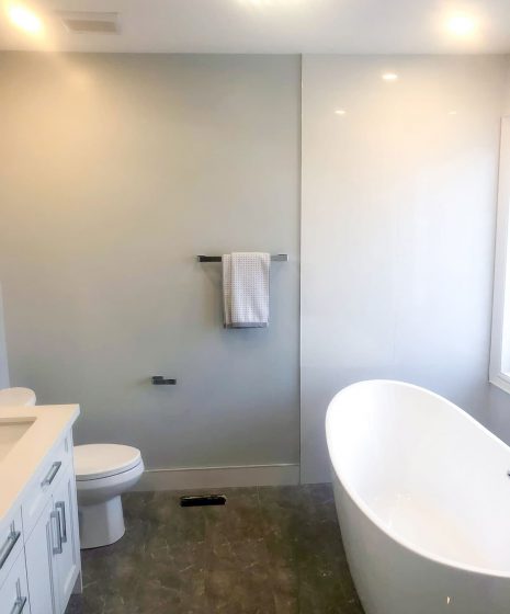 freestanding bathtub and gray wall painting in luxury bathroom -  bathroom remodel